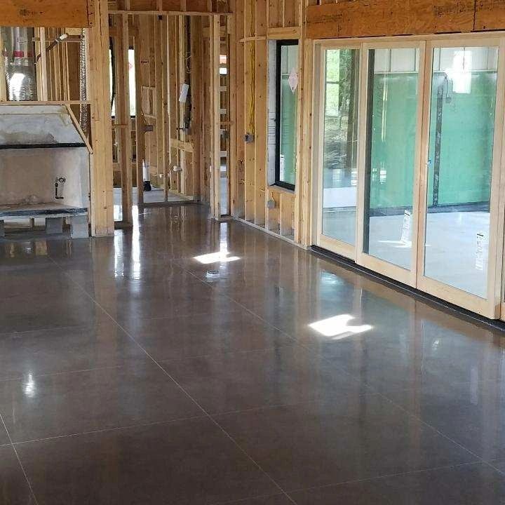 Construction space with polished concrete and green glass doors