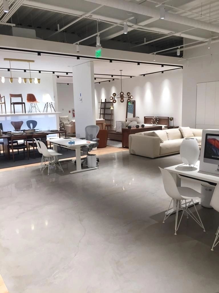 Open-concept furniture showroom with polished concrete flooring