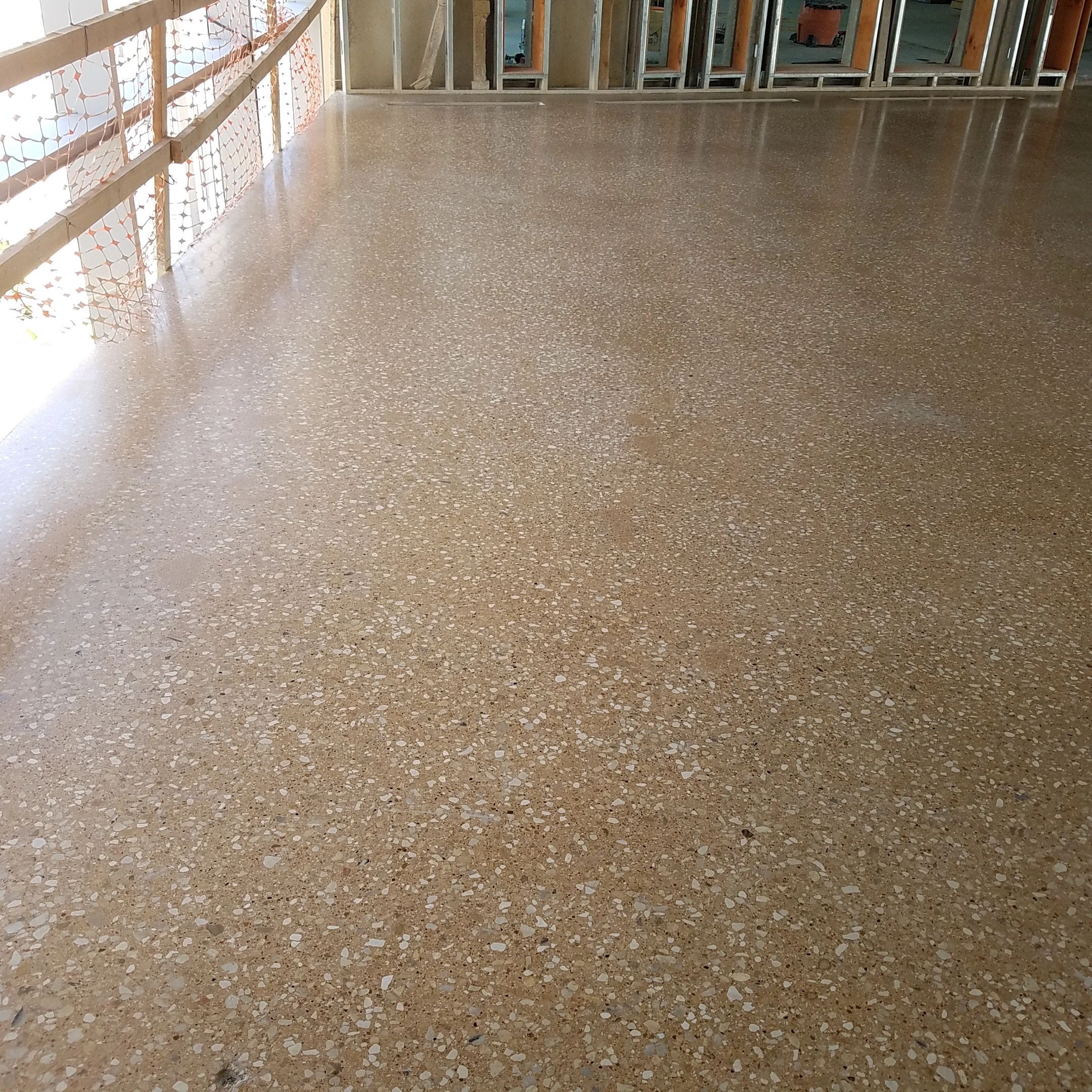 Spacious gymnasium with polished aggregate concrete floor