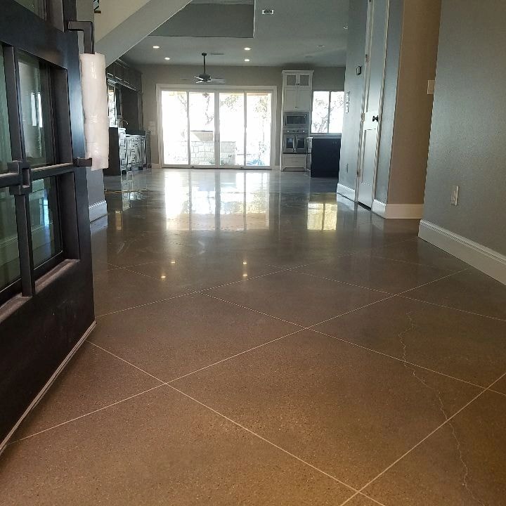 Modern kitchen with polished concrete floor and glass doors