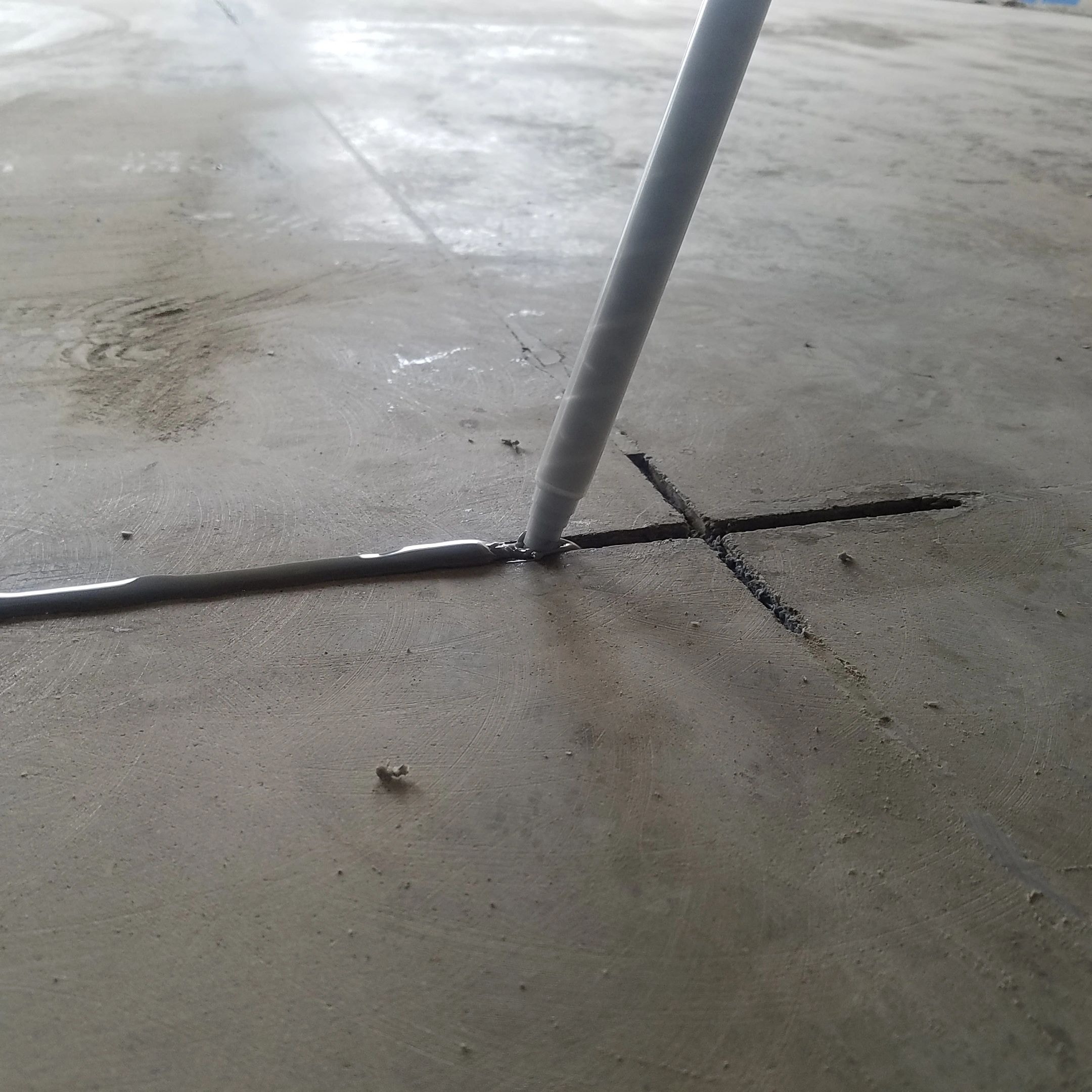 PVC pipe and electrical conduit on concrete surface